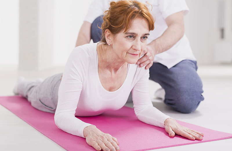 Physiotherapist helping patient regain movement at Habib Medical Clinic Abuja